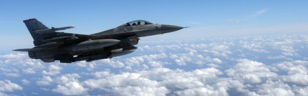 A jet fighter is flying high over a sea of clouds under a clear blue sky, 4K Desktop Wallpaper