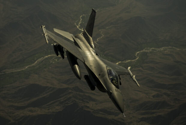 A jet fighter is flying high above mountainous land and winding rivers, 2K Desktop Wallpaper