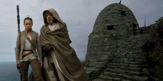Two characters from Jj Abrams stand near an ancient stone building on a coastal cliff, 2K Desktop Wallpaper
