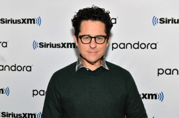 Jj Abrams wears a dark green sweater and glasses at a promotional event, 2K Desktop Wallpaper