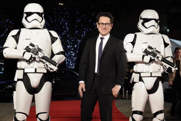 Jj Abrams stands on a red carpet with two stormtroopers in white armor at night, HD Desktop Wallpaper