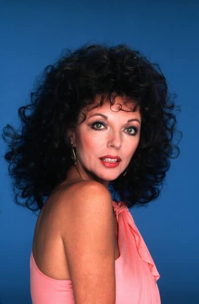 A classic portrait of Joan Collins with curly hair and a pink dress, 2K Mobile Wallpaper