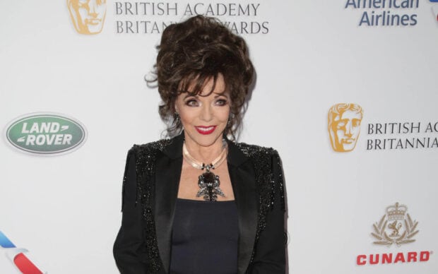 Joan Collins smiles wearing a black dress and ornate necklace at a British Academy event, HD Desktop Wallpaper
