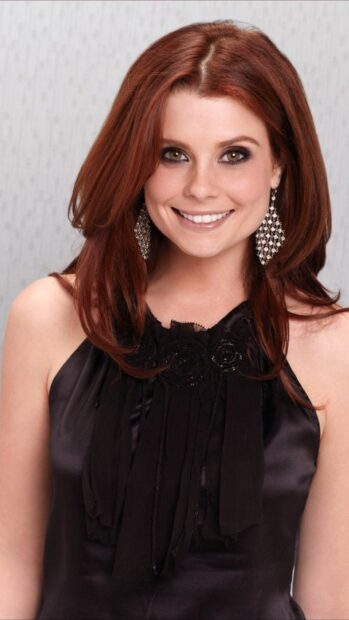 Joanna Garcia Swisher smiling confidently wearing a black dress and elegant earrings, 4K Mobile Wallpaper