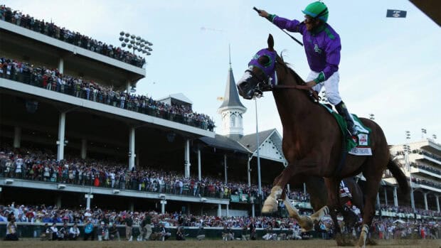 A jockey celebrates winning the Kentucky Derby horse race in front of a cheering crowd, HD Desktop Wallpaper