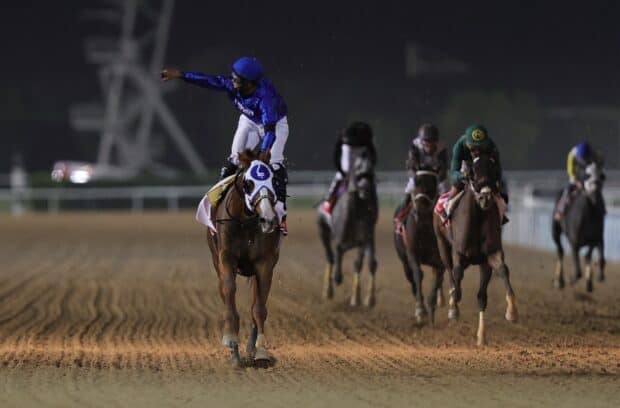 A jockey on a horse celebrates as they lead the horse racing competition at night, HD Desktop Wallpaper