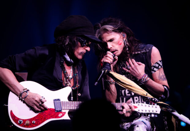 Joe Perry and Steven Tyler share a moment during a live performance with guitar and microphone, 2K Desktop Wallpaper