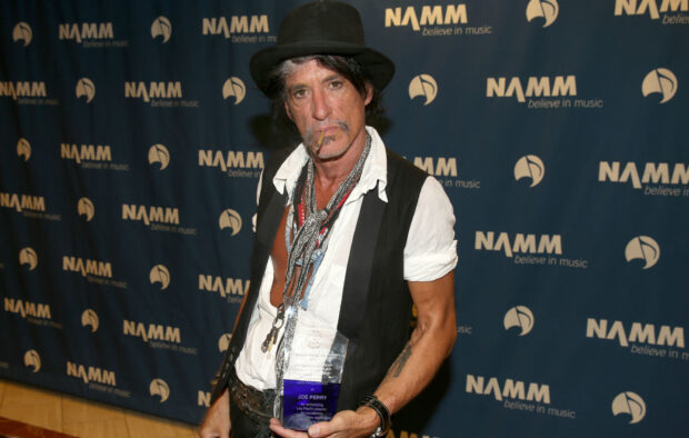 Joe Perry is holding a Les Paul Award at a NAMM music event, HD Desktop Wallpaper