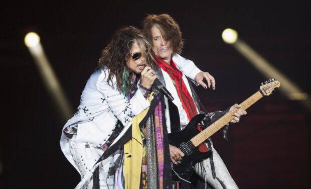 Joe Perry performing live on stage with a fellow musician during a concert, 2K Desktop Wallpaper