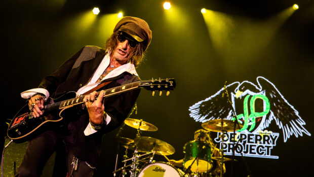 Joe Perry is playing an electric guitar during a live concert with stage lights, HD Desktop Wallpaper