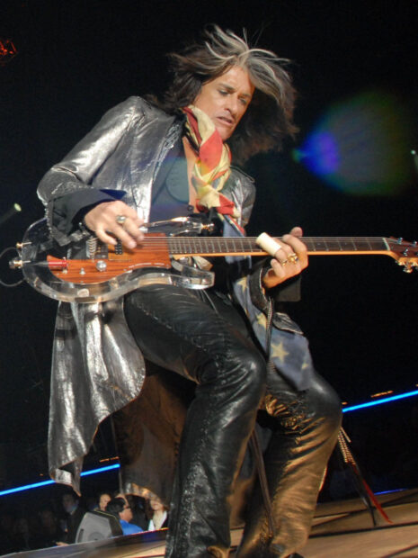 Joe Perry playing electric guitar on stage during a live concert performance, HD Desktop Wallpaper