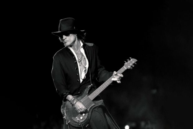 Joe Perry passionately playing guitar during a concert performance, 2K Desktop Wallpaper