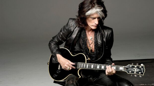 Joe Perry is playing guitar in a dark outfit and distinctive hair, HD Desktop Wallpaper