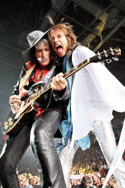 Joe Perry is playing guitar passionately on stage during a live concert, HD Desktop Wallpaper
