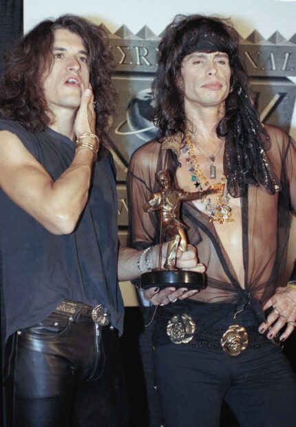 Joe Perry wallpapers show him holding a statue while dressed in a sheer top and accessories, HD Mobile Wallpaper