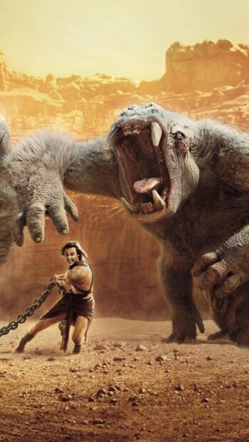 A fierce battle between John Carter and a massive beast in a desert setting, HD Phone Wallpaper