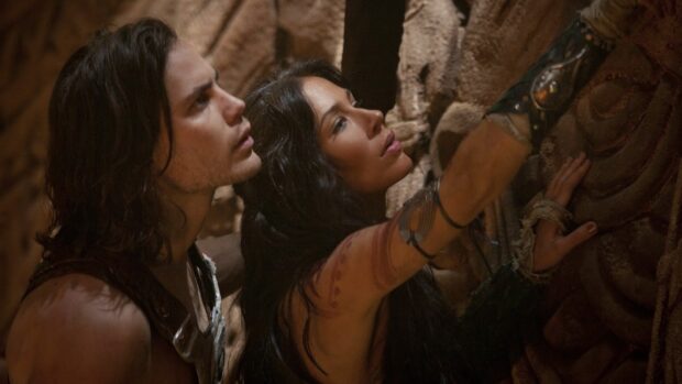 A man and woman closely examine ancient stone carvings in John Carter Wallpapers, HD Desktop Wallpaper