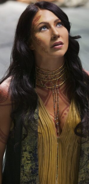 A woman with facial tattoos and jewelry looks upward embodying John Carter wallpapers, 2K Mobile Wallpaper