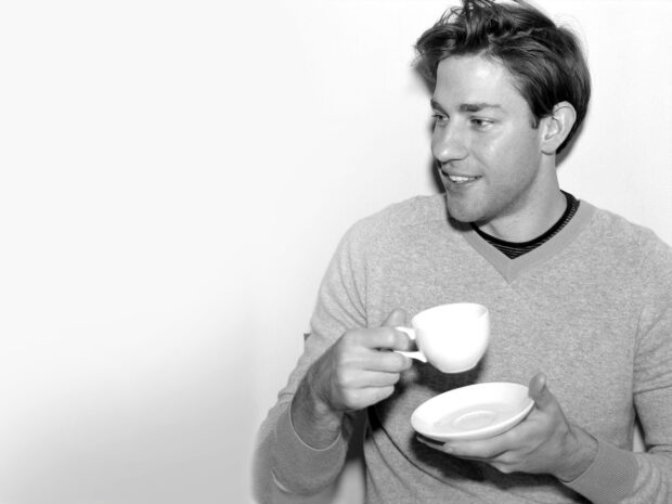 John Krasinski holding a white cup and saucer in a black and white photo, 2K Desktop Wallpaper