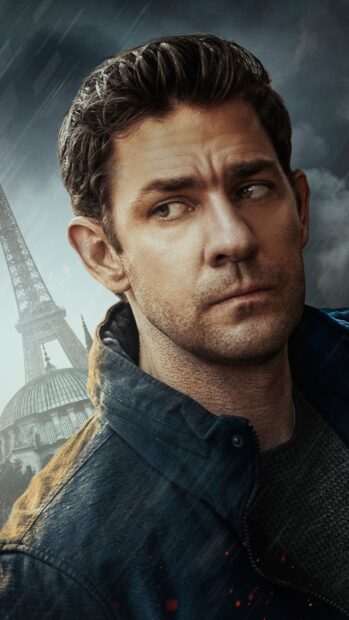 A close up of John Krasinski showing an intense look with famous landmarks in the background, 2K Phone Wallpaper