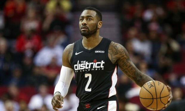 John Wall is seen dribbling the basketball focused on the court, 2K Desktop Wallpaper