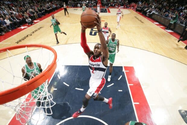 John Wall is jumping close to the basket while opponents watch on the court, 2K Desktop Wallpaper
