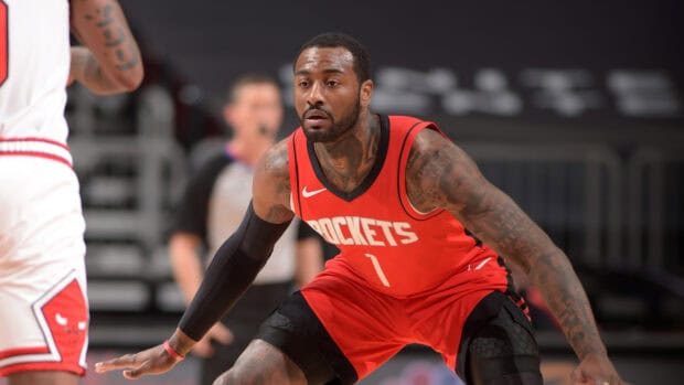 John Wall is defending during a basketball game while wearing a red Rockets jersey, HD Desktop Wallpaper