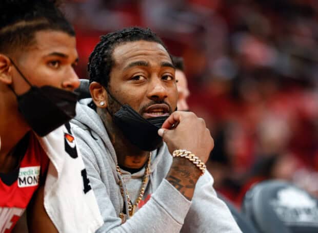 John Wall is sitting courtside wearing a grey hoodie and gold jewelry, HD Desktop Wallpaper