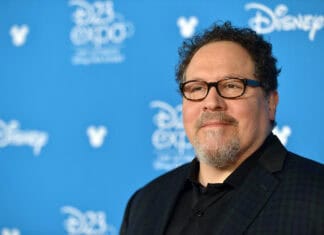 Jon Favreau Wallpapers shows a man wearing glasses and a dark jacket at a Disney event, HD Desktop Wallpaper