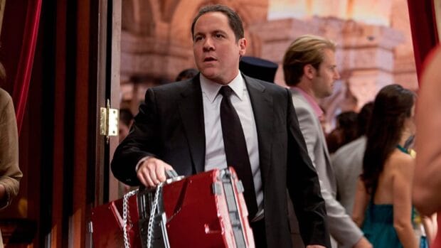 Jon Favreau in a suit holding a red case at an event, HD Desktop Wallpaper
