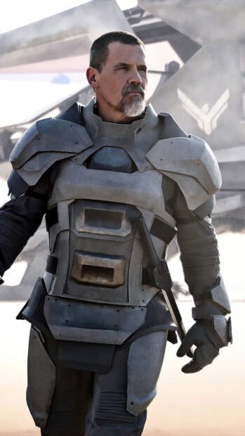 Josh Brolin wears futuristic armor standing confidently with a blurred background, HD Mobile Wallpaper