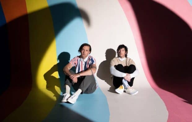 Josh Dun and bandmate sitting on floor with shadows and colorful background, HD Desktop Wallpaper