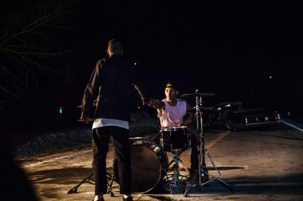 Josh Dun is playing drums during a night performance on the street, HD Desktop Wallpaper