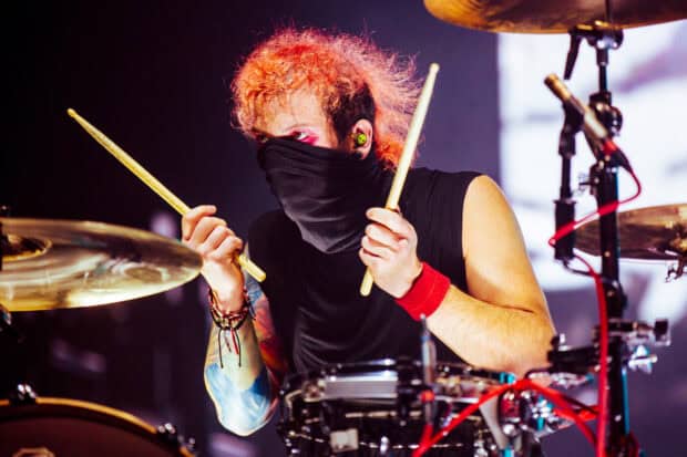 Josh Dun is playing the drums with intensity wearing a black face cover and red wristband, HD Desktop Wallpaper