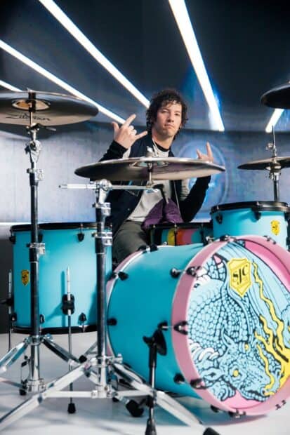 Josh Dun Wallpapers showing a drummer with a blue drum set and colorful bass drum design, HD Mobile Wallpaper