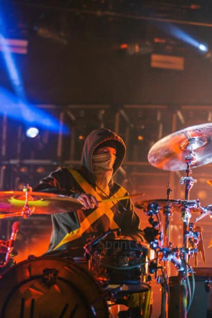 Josh Dun is performing live wearing a hoodie and bandana while playing the drums, HD Mobile Wallpaper