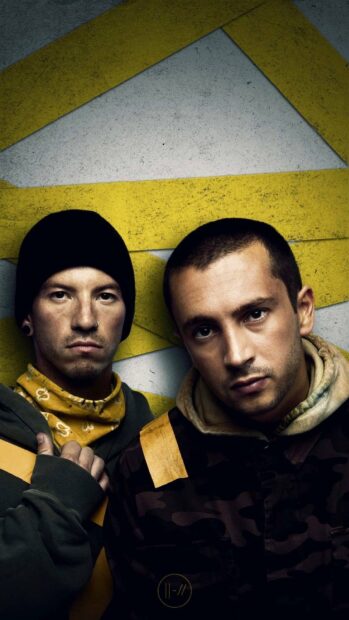 Josh Dun stands beside bandmate in front of a yellow patterned wall, HD Phone Wallpaper