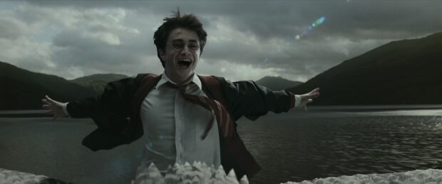 A character celebrates near a lake in The Prisoner Of Azkaban scene, 4K Desktop Wallpaper