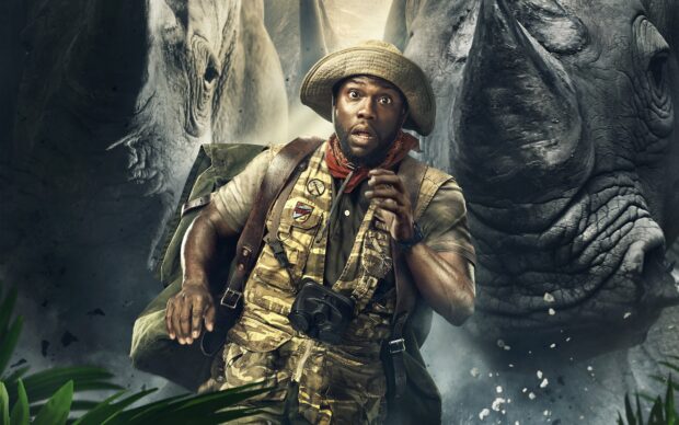 A man in adventure gear looks surprised while running past two rhinos in Jumanji The Next Level wallpapers, 2K Desktop Wallpaper