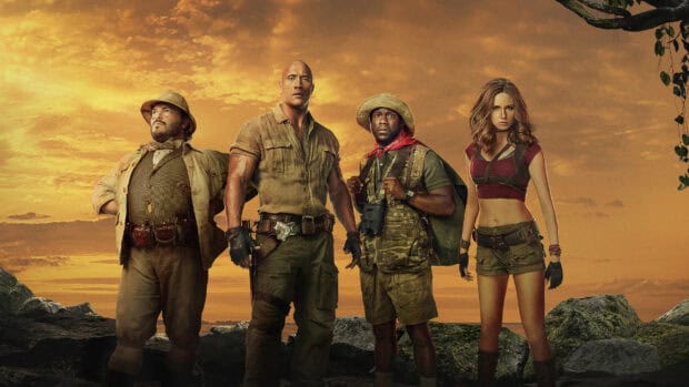 The main cast of Jumanji The Next Level stands together against a vivid sunset sky, 2K Desktop Wallpaper