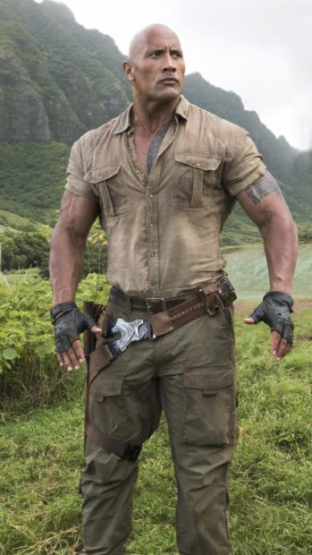A muscular man stands in a jungle setting wearing adventure gear from Jumanji The Next Level, HD Phone Wallpaper