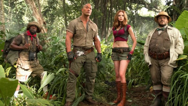 The main characters from Jumanji The Next Level stand determined in a lush jungle setting, 4K Desktop Wallpaper