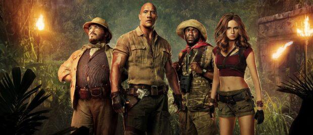 The Jumanji The Next Level characters stand ready in a dense jungle setting with torches lit behind them, 4K Desktop Wallpaper
