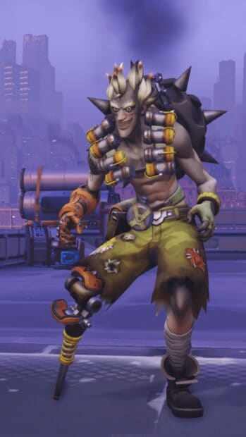 Junkrat is standing on an urban rooftop with a mischievous grin, HD Phone Wallpaper