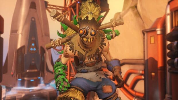 Junkrat character is shown with a mechanical arm and a detailed mask, HD Desktop Wallpaper