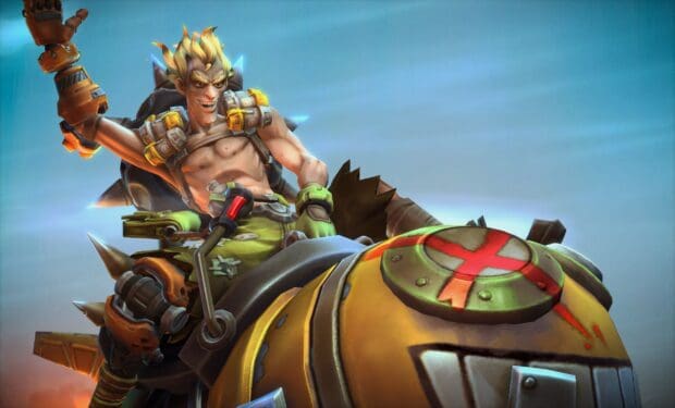 Junkrat is shown riding a large bomb with a mischievous grin, 2K Desktop Wallpaper