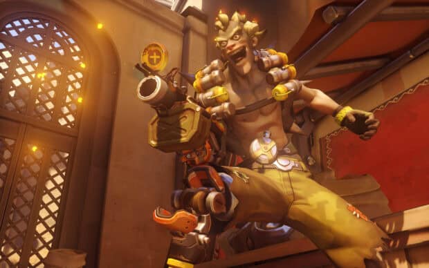 Junkrat is holding explosives with a fierce expression indoors, HD Desktop Wallpaper