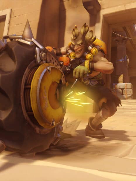 Junkrat is seen preparing his explosive tire in a desert arena, HD Mobile Wallpaper