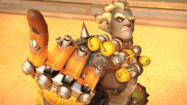 Junkrat stands confidently with an extended mechanical glove and explosive grenades, HD Desktop Wallpaper