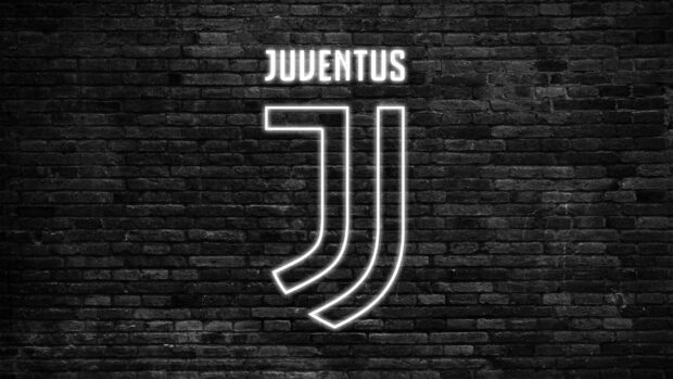 The Juventus emblem glows brightly against a dark brick wall, HD Desktop Wallpaper